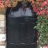 Virginia Creeper in Autumn surrounding a doorway to a walled garden in England